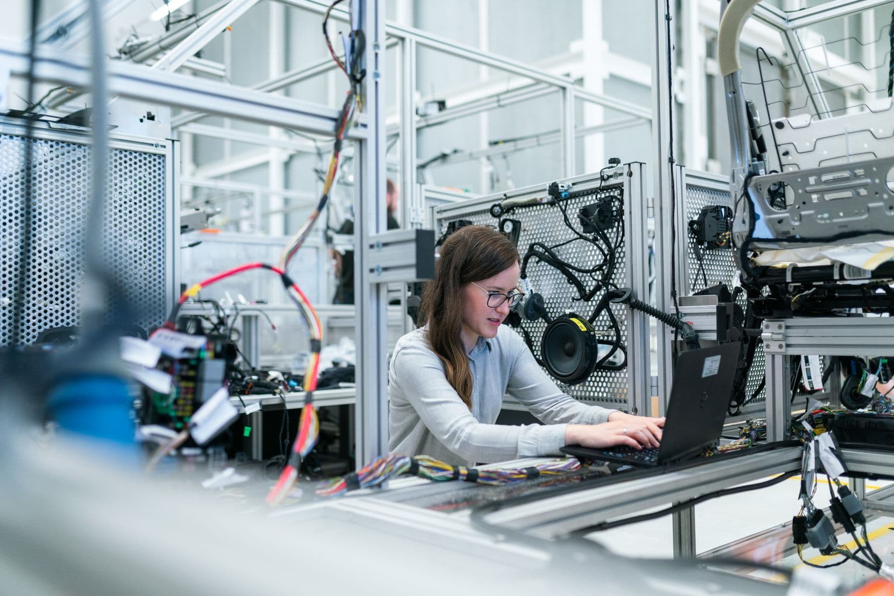 Technician reviewing equipment status on a laptop inside a facility